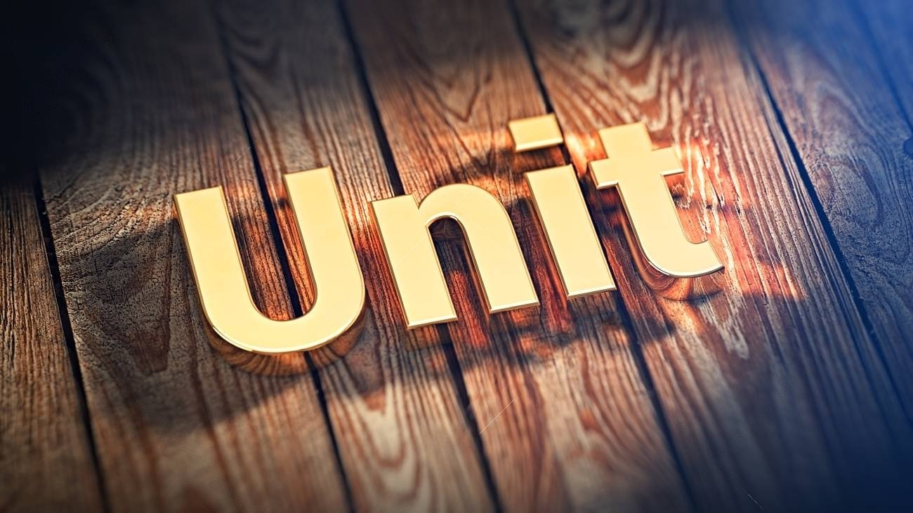 61949713-the-word-unit-is-lined-with-gold-letters-on-wooden-planks-3d-illustration-image-transformed Home